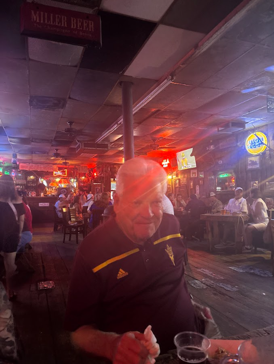 Ed Edling wears an Arizona State polo while seated at a restaurant table in College Station.