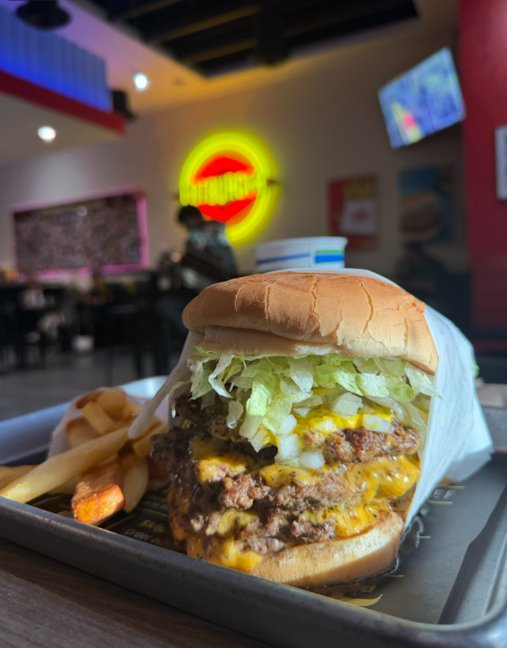 The Fatburger XXXL Triple King — three half-pound patties stacked on a tray at the Cave Creek location on Tatum Boulevard.