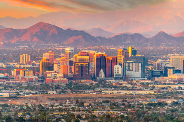 Phoenix skyline at sunset, with the South Mountain range in the background.